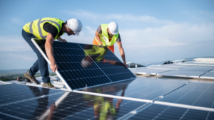 Two workers installing solar panels