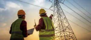 Two workers looking at power lines